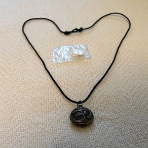 Aromatherapy locket necklace with adjustable strap and four pads for oil.